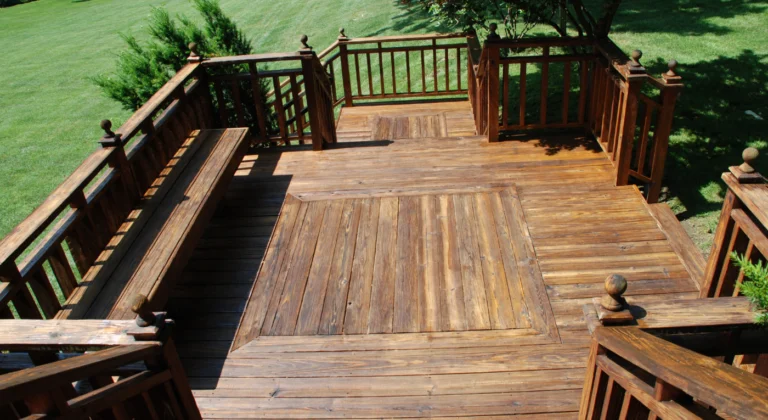 Wood deck with railings and stairs overlooking a garden
